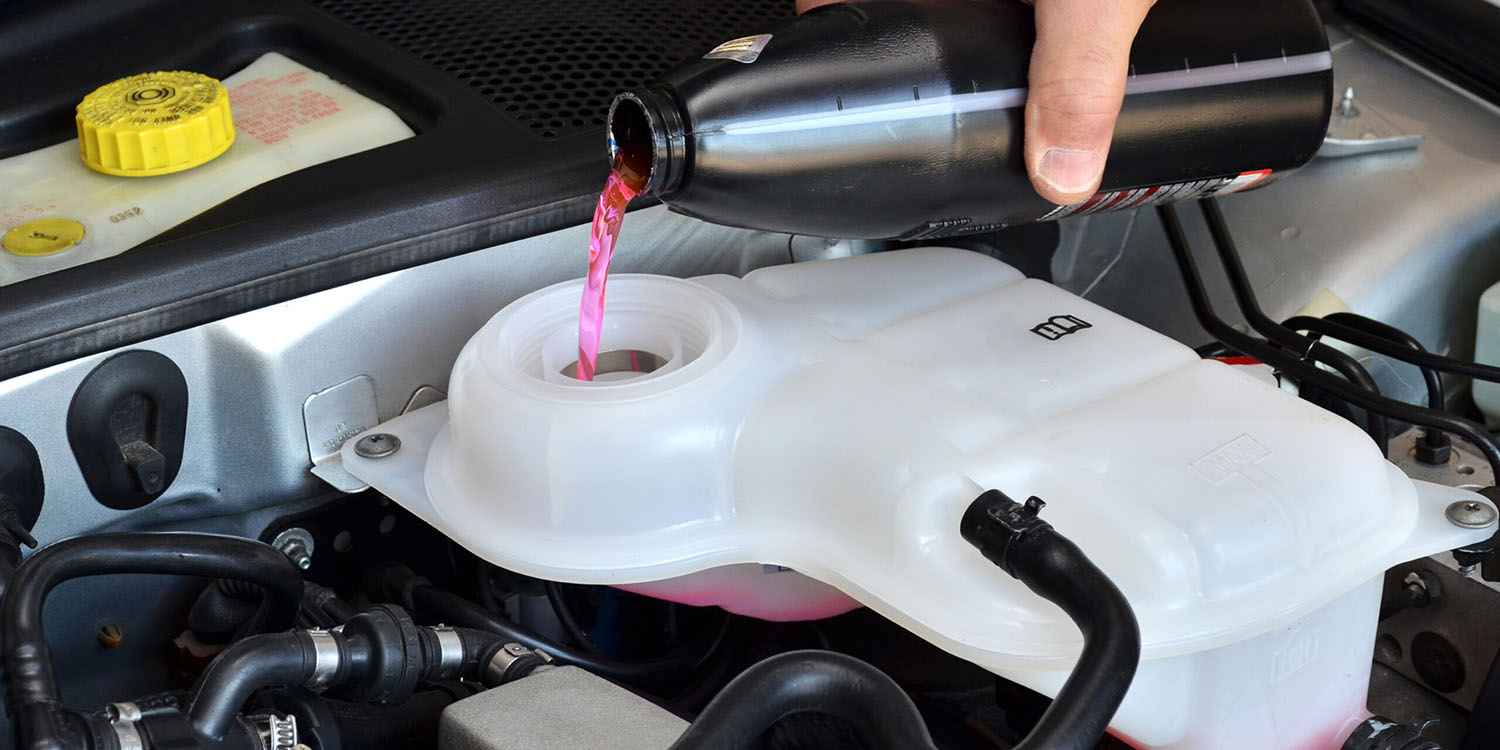 Coolant being added to a vehicle expansion tank during cooling-system service