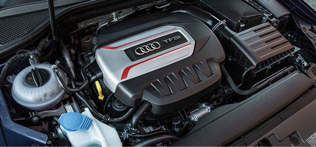 Audi engine bay showing the coolant expansion tank and cooling-system hoses