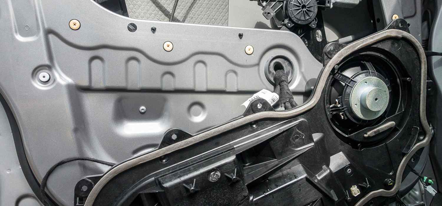 Inside an Audi door during mechanical and electrical repair inspection