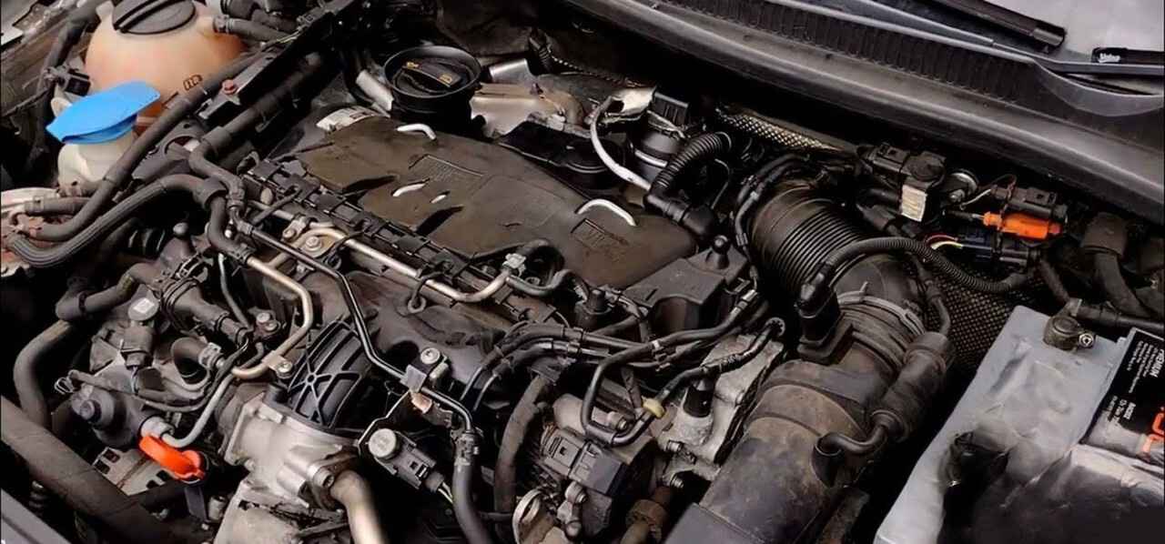 Engine bay showing intake pipework, hoses and electrical connections